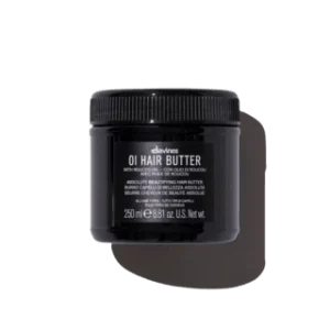 A black jar with a textured lid contains hair butter