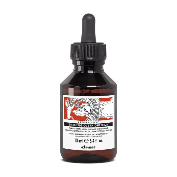 A dark glass bottle with a dropper cap contains a lightweight serum with floral and graphic labeling