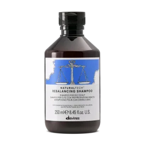 A brown bottle with a blue label features a scale symbol, indicating balance