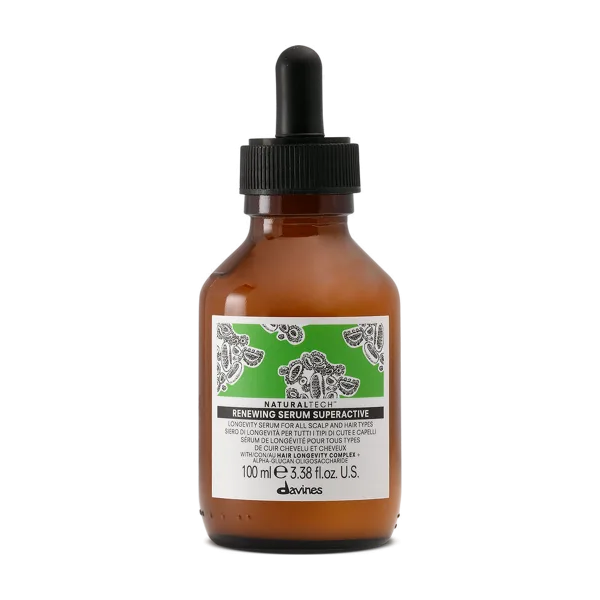 A small amber glass bottle with a dropper cap contains a green serum