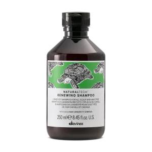 A dark bottle of shampoo features a green label with a turtle design