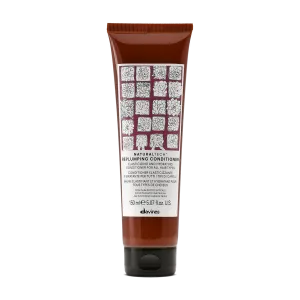 A brown tube of conditioner with a patterned design on the label
