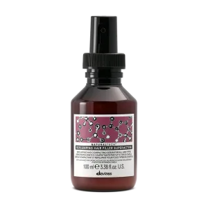 A sleek spray bottle with a colorful label featuring molecular designs