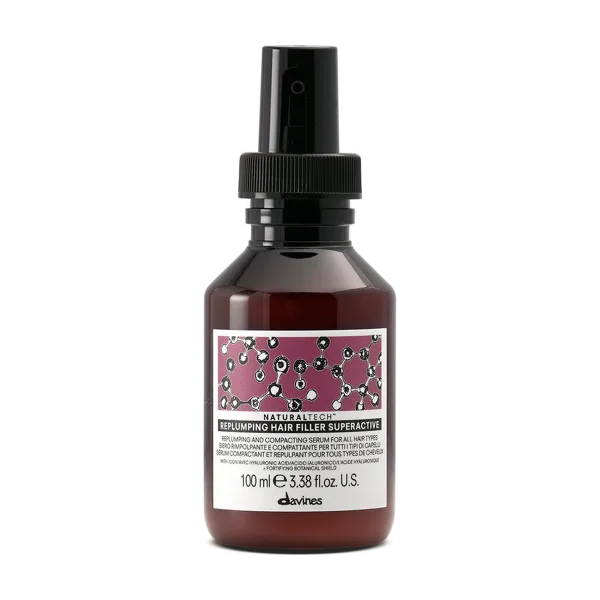 A sleek spray bottle with a colorful label featuring molecular designs