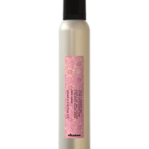 A sleek, silver bottle with a decorative pink label stands upright