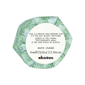 A hexagonal container with a floral design displays product information on a label