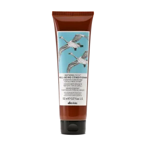 A tube of conditioner features a design with flying cranes on a blue background